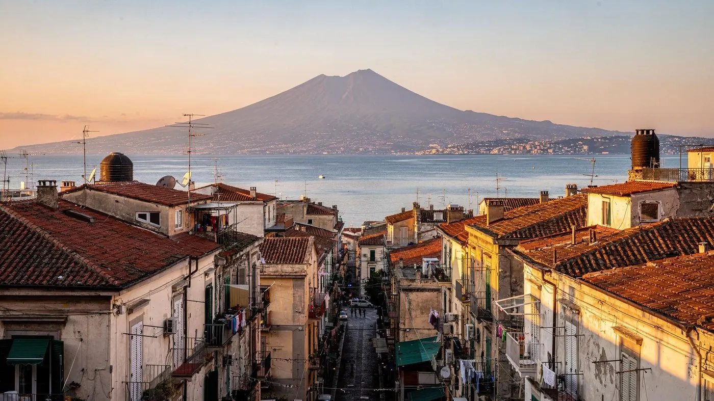 Naples, the best Italian city for food: rooftops running down to the bay with Vesuvius across the water