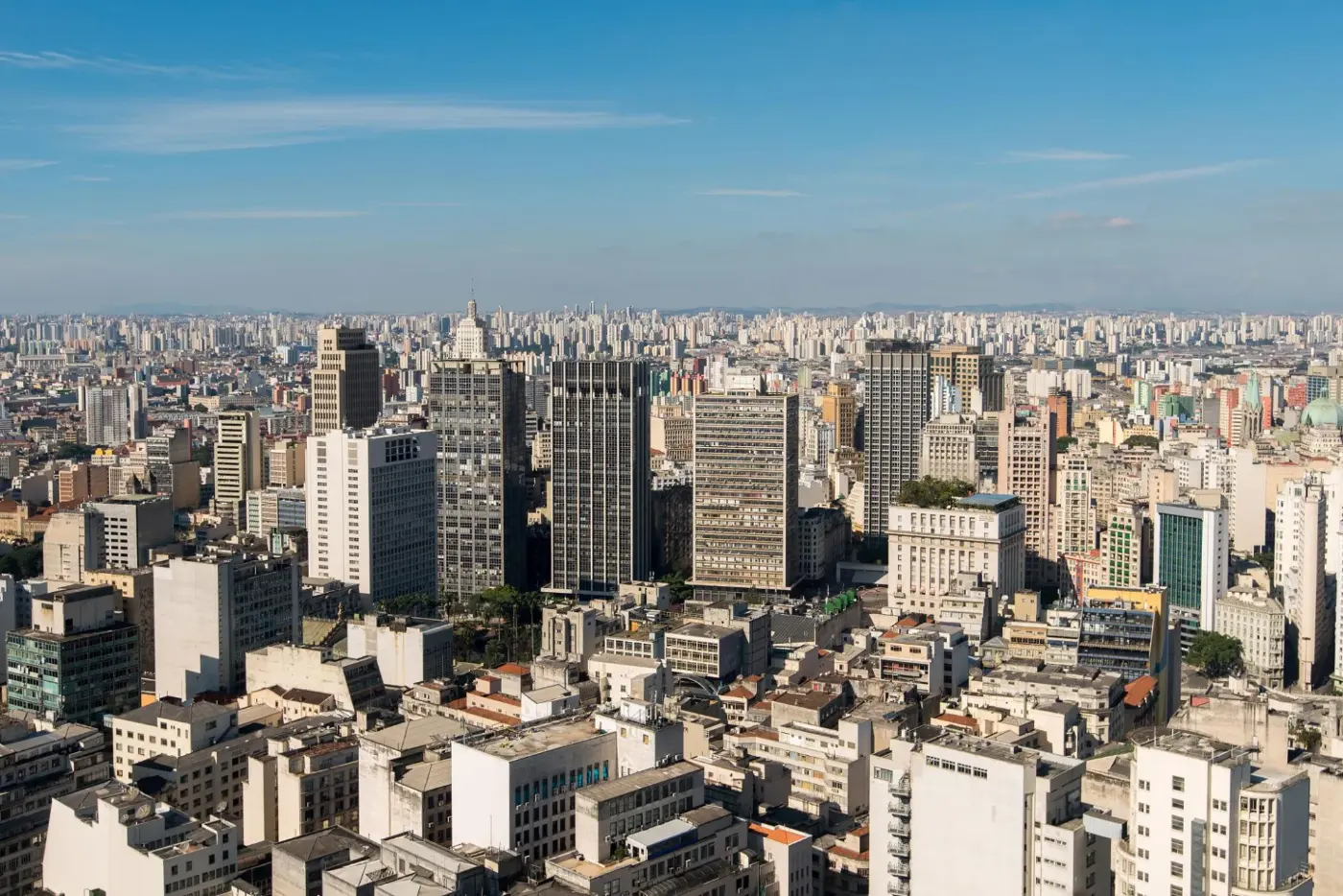 The São Paulo skyline, high-rise towers stretching to the horizon under a clear sky