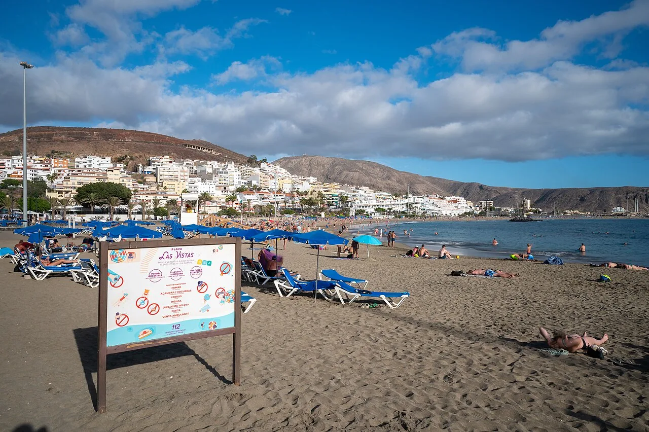Playa de las Vistas in southern Tenerife, with sunloungers on the sand and the town rising behind the bay